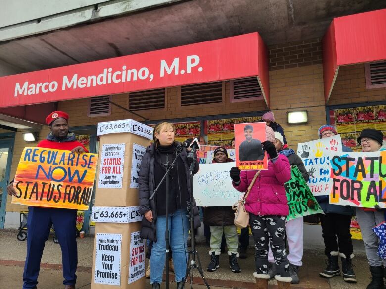 A rally is held outside public safety minister Marco Mendicino's office calling for a regularization program for migrants in Canada. Dec. 16, 2022.