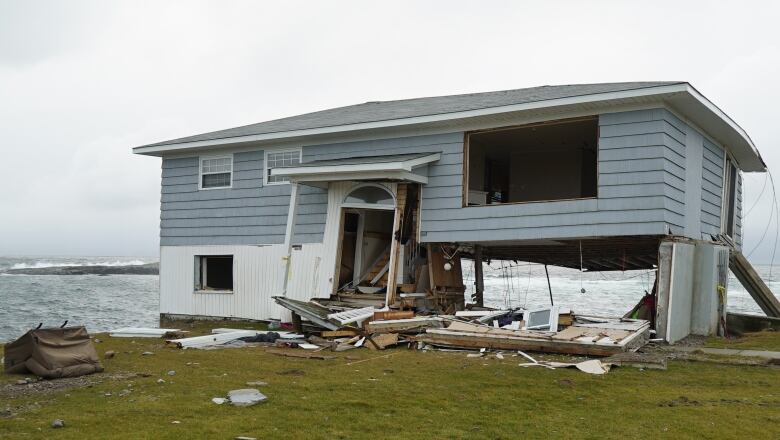 A home with severe damage in Port aux Basques. The front door, windows and a portion of the first floor are all blown out. 