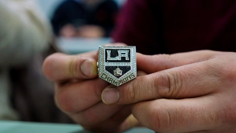 A close up of the ring, it is filled with diamonds making up the Los Angeles Kings's logo. 