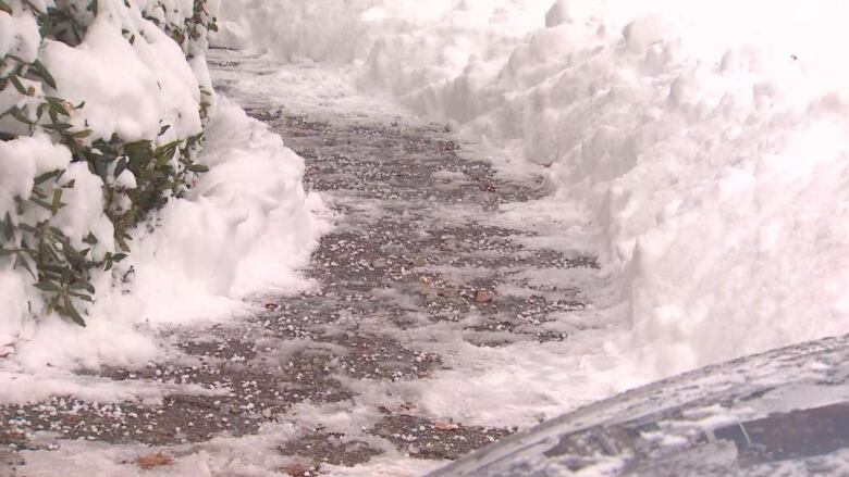 A snow and ice-covered sidewalk.