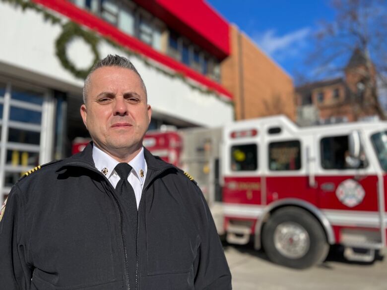 Charlottetown Fire Chief Tim Mamye stands in front of a fire truck at a city fire station.