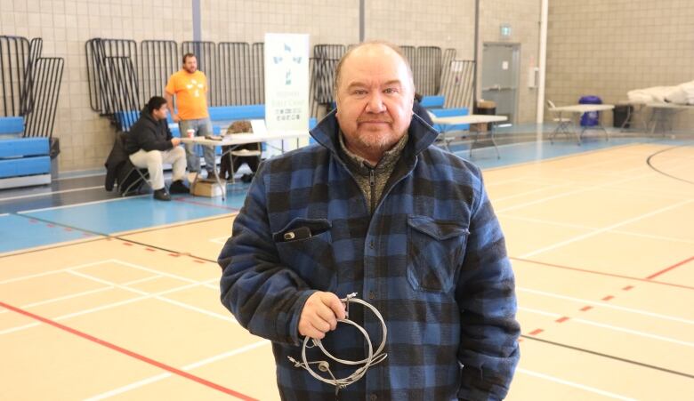 Man standing in gymnasium.