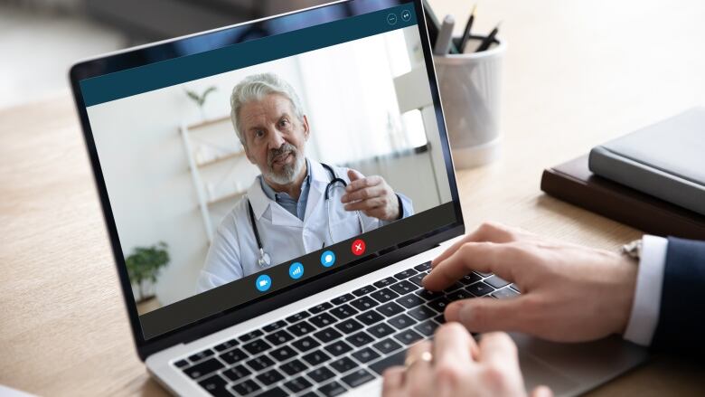 A stock image of a man dressed as a doctor on a computer screen