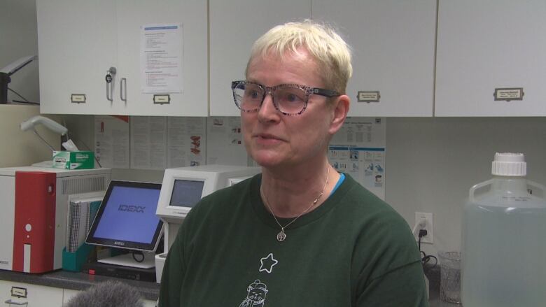 Portrait of a person in a lab room.