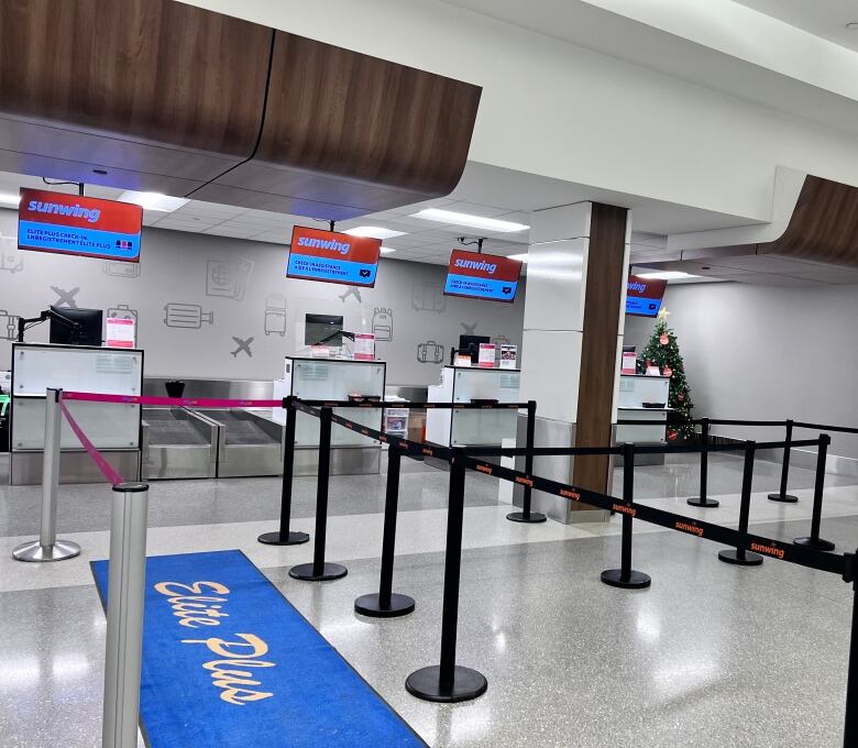 A check-in space for Sunwing Saskatoon's airport is pictured empty, without passengers or workers seen. 