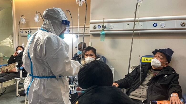 A medical worker in a hazmat suit looks after patients in Shanghai.