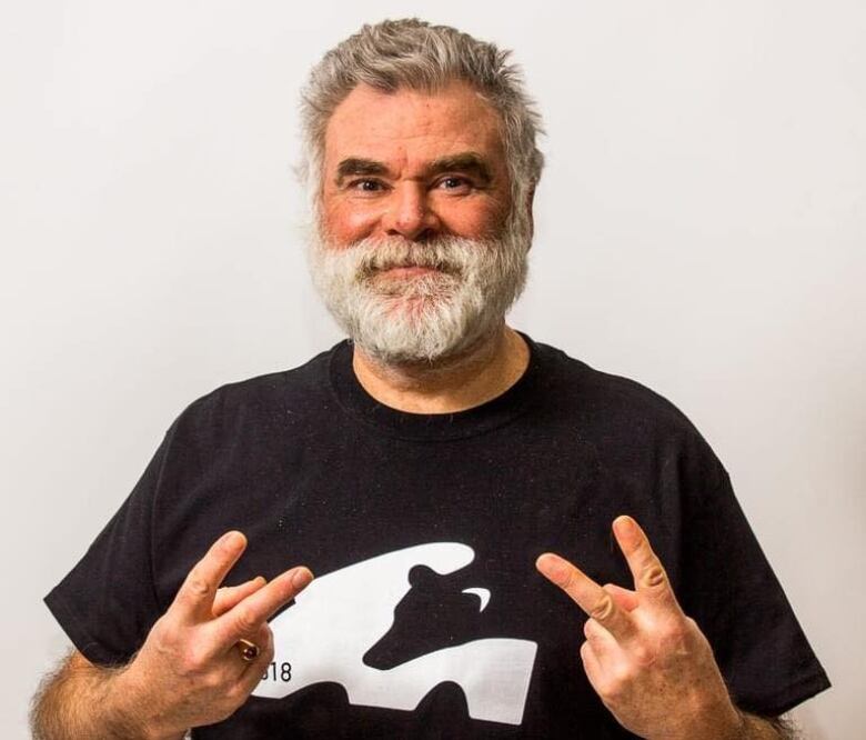 A man named Robert MacLellan with grey hair and a beard wears a black t-shirt in a Facebook profile photo.