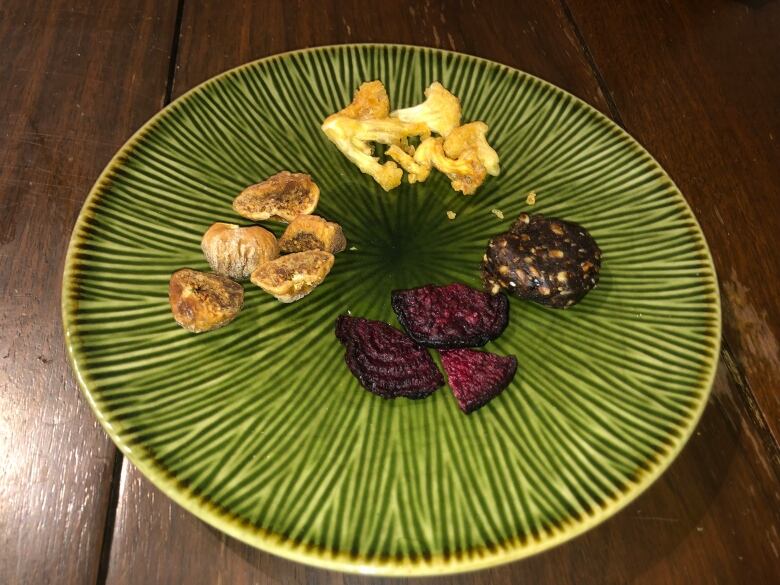 A plate with cannabis-infused dried cauliflower, beets, figs and blackcurrent bites.