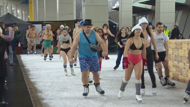 Skaters dressed in their bathing suits or underwear skate at The Bentway skating trail.