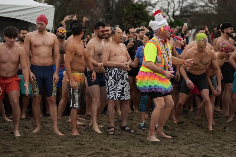 A 90-year-old man waits with others to participate in a polar bear swim on New Year's Day.