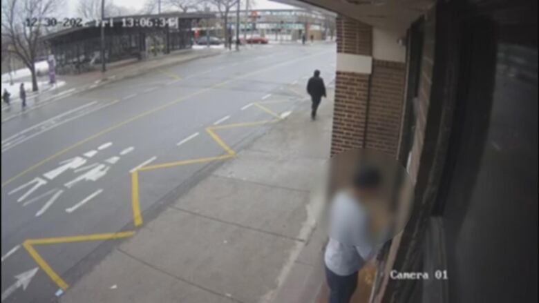 Blurred footage of man pulling on a door seen from above. 