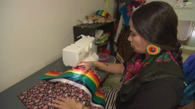 Tala Tootoosis making a ribbon skirt