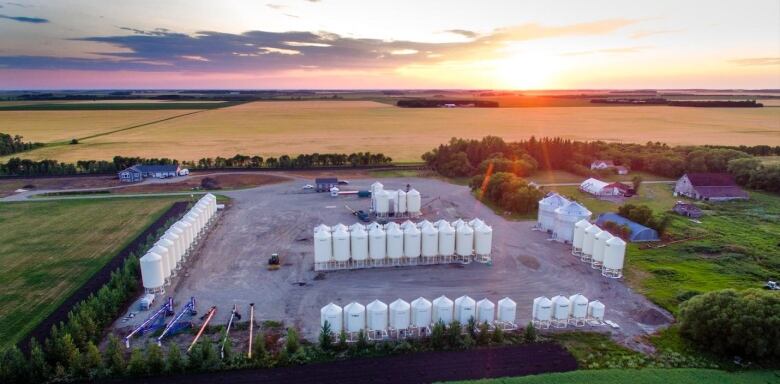 An arial view of sunset on a large farmyard.