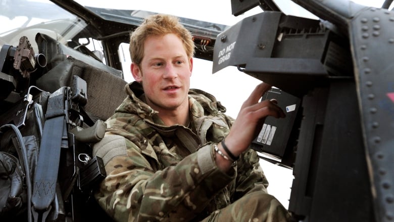 A person is seen inside a helicopter cockpit.