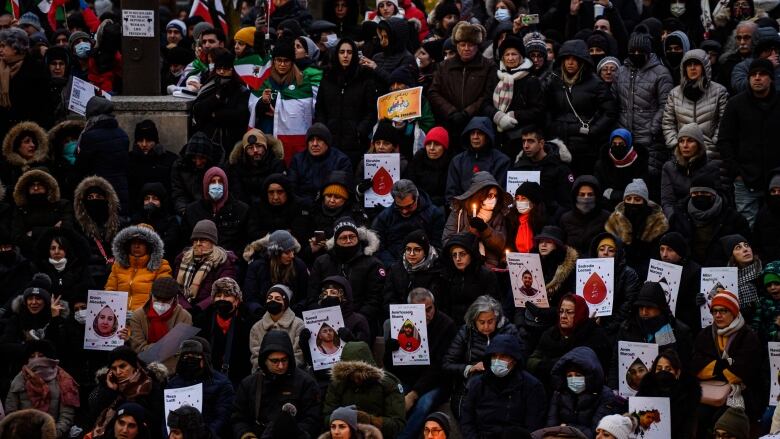 People attend a vigil marking the three year anniversary of the downing of flight PS752, in Toronto on Sunday, Jan. 8, 2023.