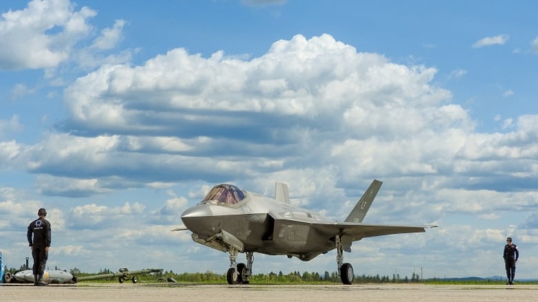 A fighter jet is on a tarmac