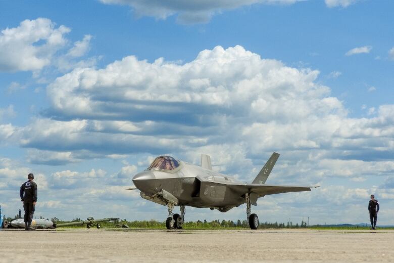 A fighter jet is on a tarmac