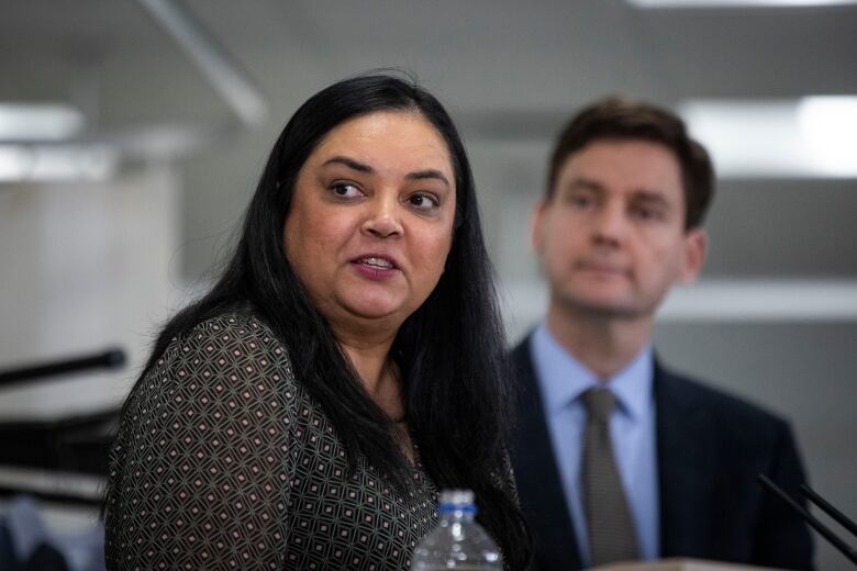 Aman Grewal, president of the BC Nurses Union is pictured near Premier David Eby during a press conference at Langara College in Vancouver, British Columbia on Monday January 9, 2023. 