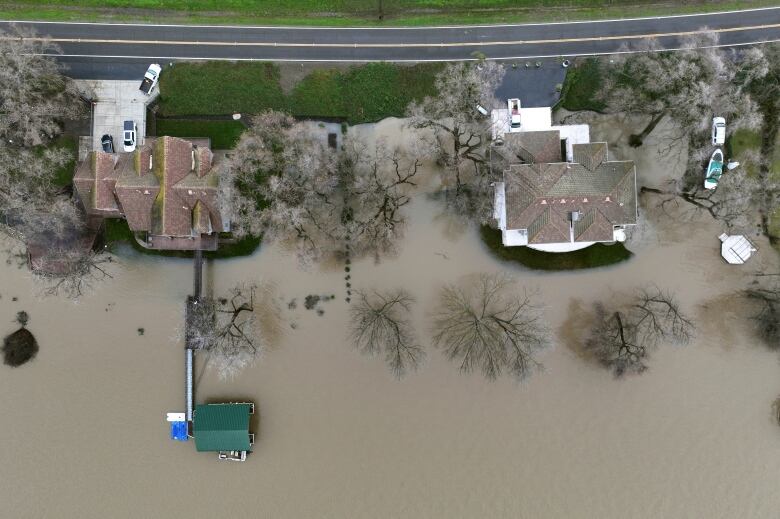 A bird's-eye view shows water surrounding homes in a part of West Sacramento, Calif., on Wednesday, Jan. 11, 2023.