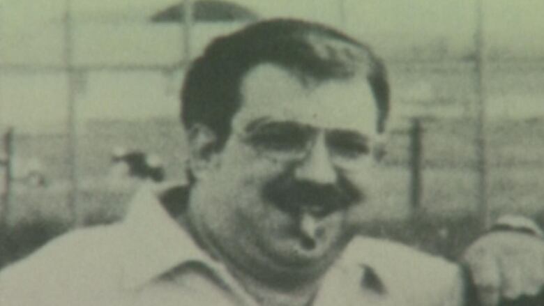 A man with a moustache and cigar is pictured in an undated photo.