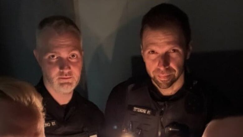 Two Nelson Police Department officers are pictured holding candles.