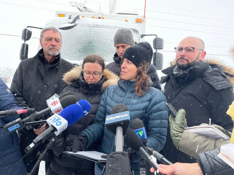 Woman talks into microphone. 