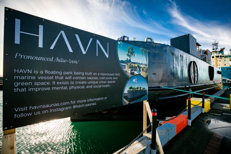 A sign by the barge says HAVN will offer saunas, cold pools, and green space. 