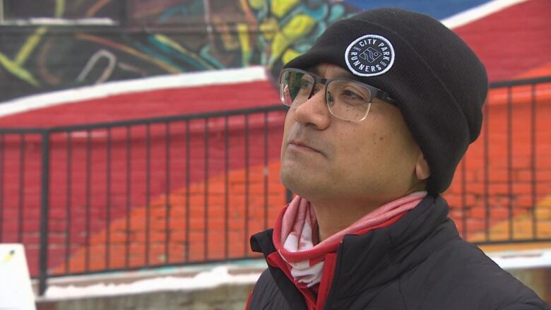 A man in a toque and glasses.