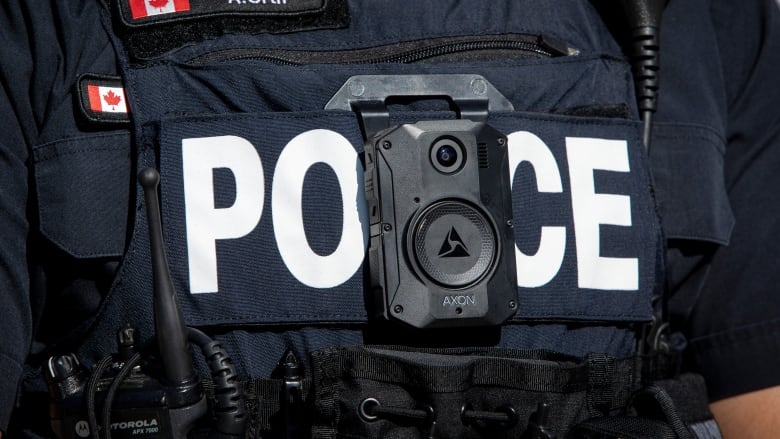 A Toronto police officer displays a body worn camera.