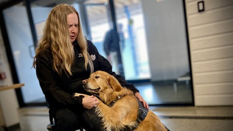 Diane Bergeron, president of CNIB Guide Dogs, poses alongside her guide dog, Carla, at the canine campus in Carleton Place, Ontario.