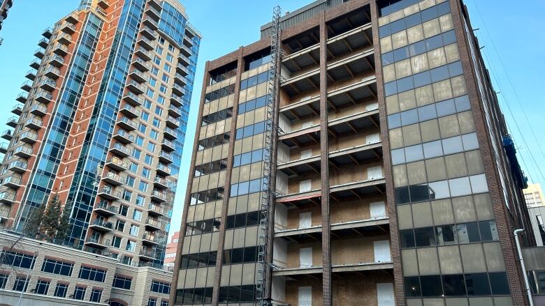 A 10-storey office building being converted to residential units. The middle of the building is being turned into two rows of balconies.