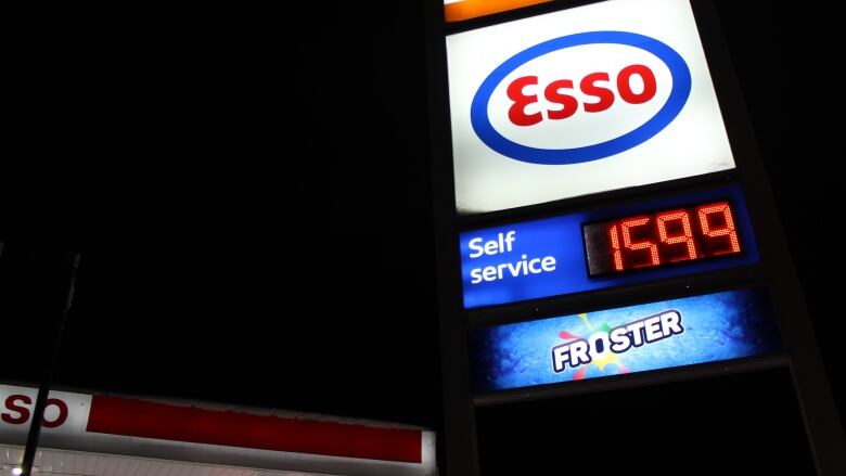 A sign of the price of gas, at $159.9 per litre, at night.