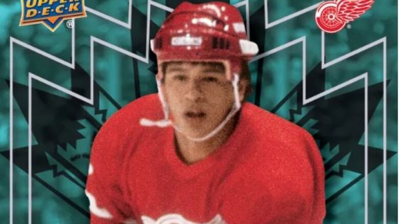 A close up of a hockey player in a red uniform.