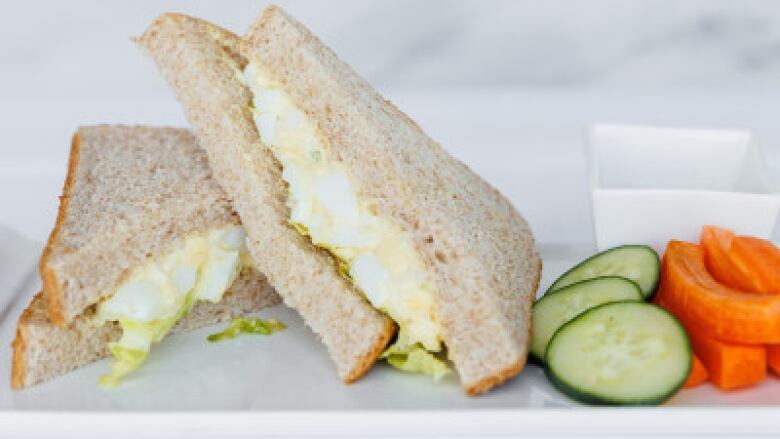 Egg salad sandwich with cucumber and carrots