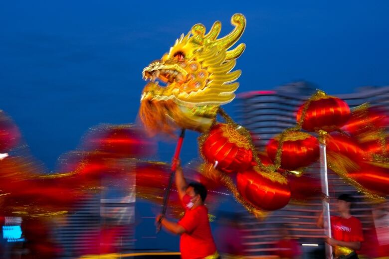 People perform in a lion dance ahead of Lunar New Year in Bangkok.