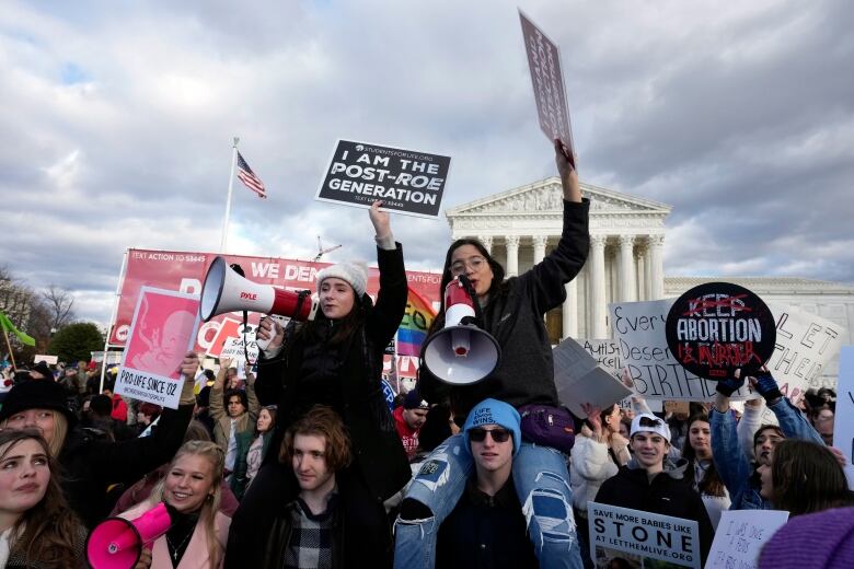 Demonstrators gather at a rally.