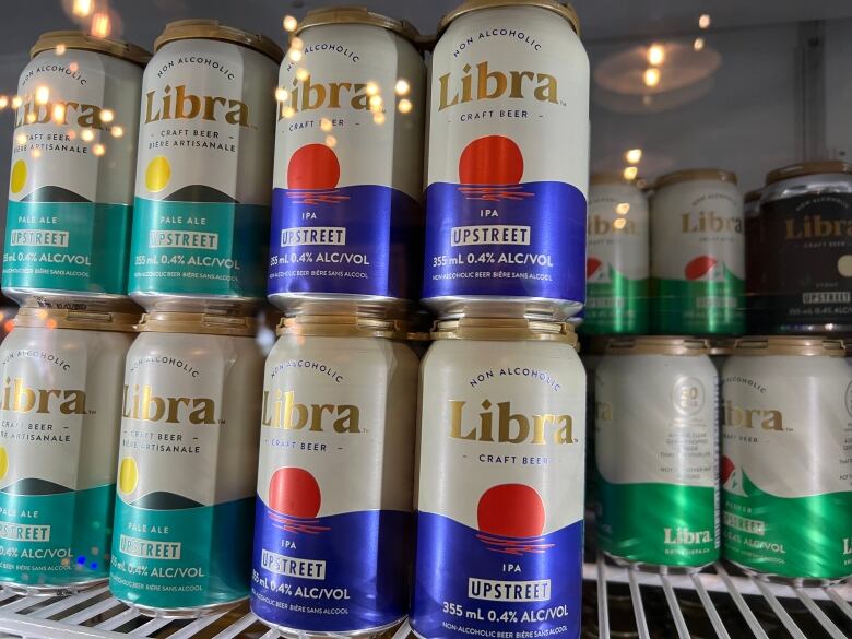 The inside of a fridge filled with non-alcoholic beer cans. 