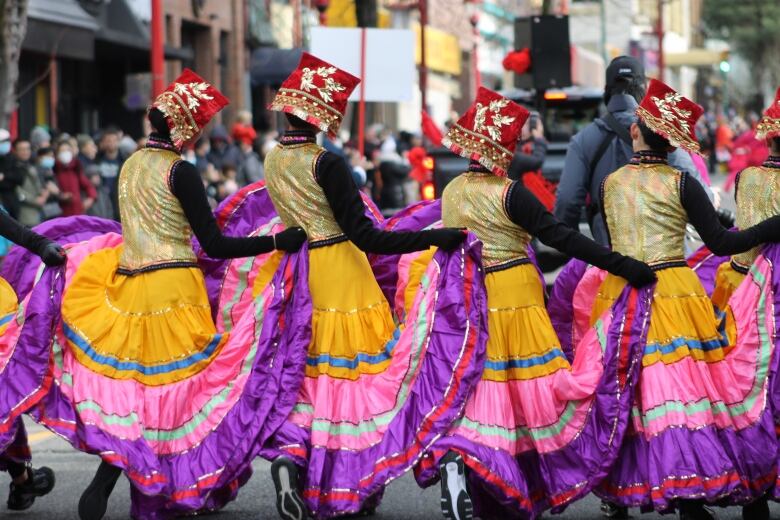 Dancers perform during a parade.