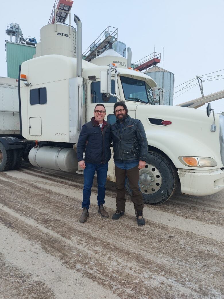 David Froh, vice-president of the Regina Food Bank, poses for a photo with Ken Tatarliov, owner of Suprise Valley Farms. 