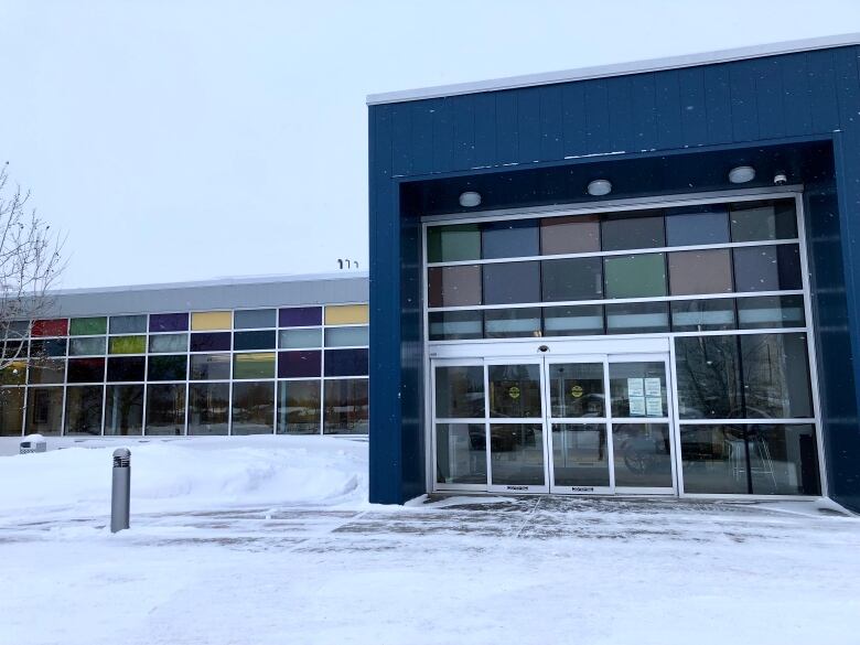 The outside of a building. There is snow on the ground.