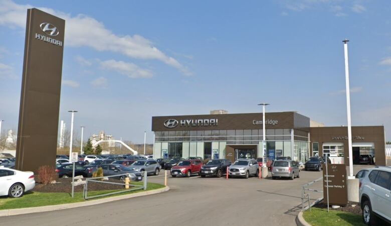 A wide-angle photograph of a glass-fronted industrial building that says 