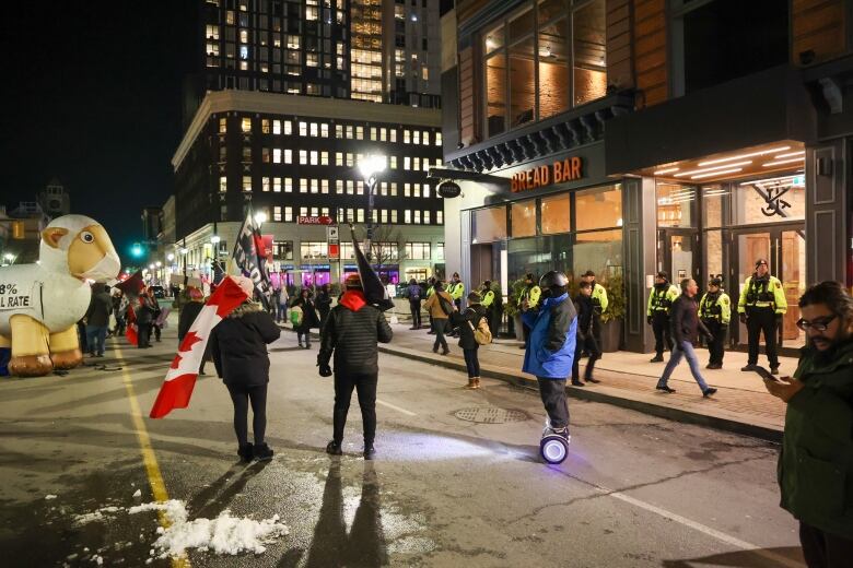 Protesters are seen outside a Hamilton restaurant.