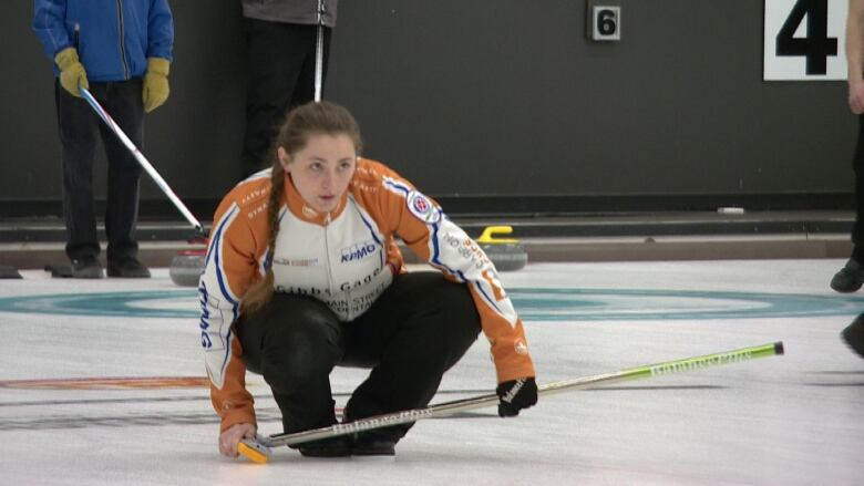 A woman stares down a shot during a practice session in preparation for the 2023 Viterra Scotties Women's Provincial tournament being held in Estevan, Sask.