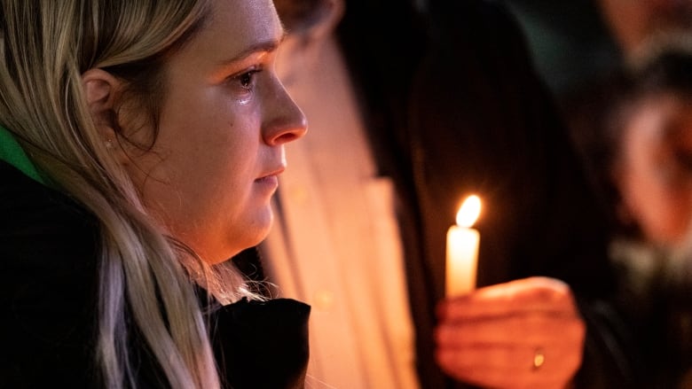 Close-up of a woman holding a candle