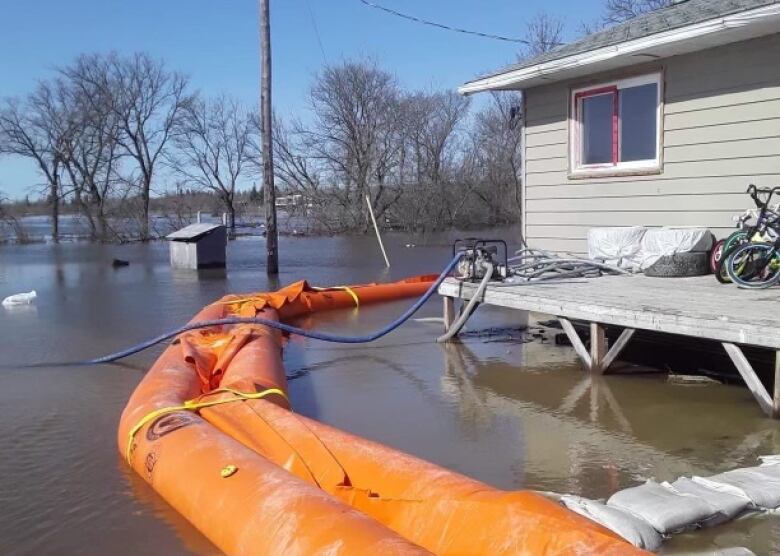 A home on Peguis First Nation is surrounded by a Tiger dam and floodwaters. 