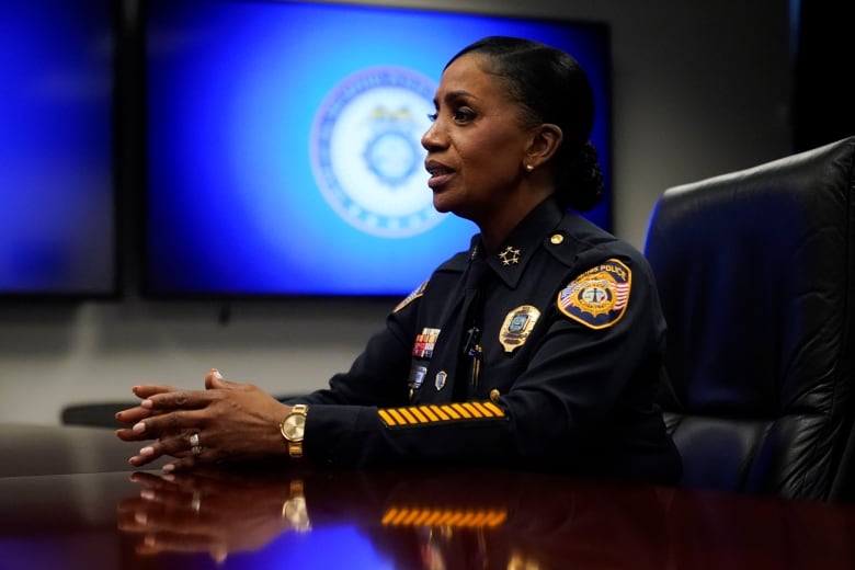 A police officer is seen seated during an interview.