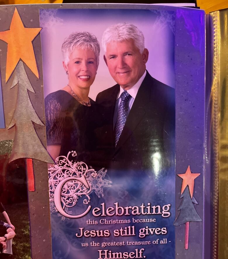 A white-haired couple dressed in formal attire pose for a Christmas card image, which reads: 'Celebrating this Christmas because Jesus still gives us the greatest treasure of all. Himself.'