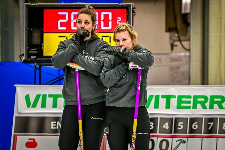 Robyn Silvernagle and Kelly Schafer look on during the Scotties provincial playdowns in Estevan.