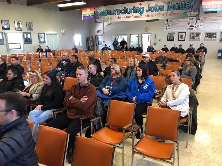 people sitting in rows of chairs