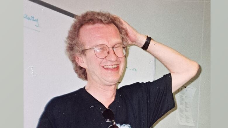 Former CBC journalist Michael Finlay is pictured wearing a black t-shirt that reads 